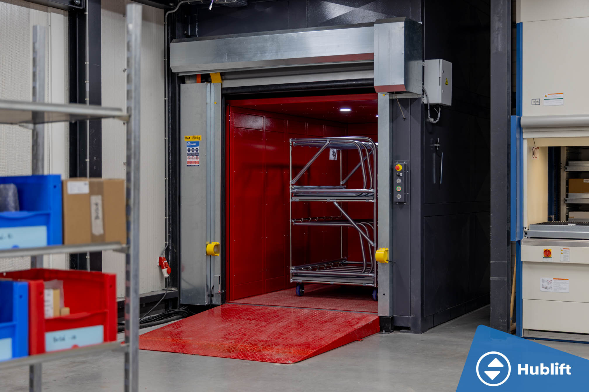 Goods lift with open high-speed roller door and roll container in the car at Veth Propulsion